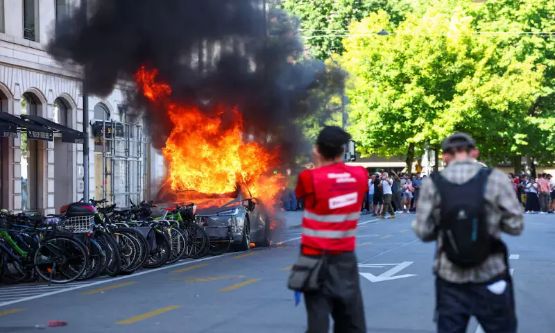 Protesters Set Tesla Ablaze During UN Office Attack in Geneva Anti-G7 Rally